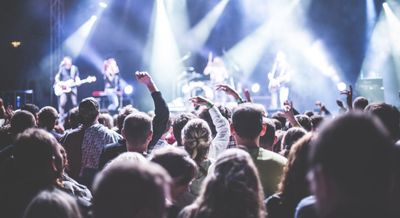 Photo of a gig with people dancing in front of the stage